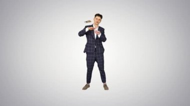 Genç mutlu iş adamı dans ediyor ve para saçıyor..
