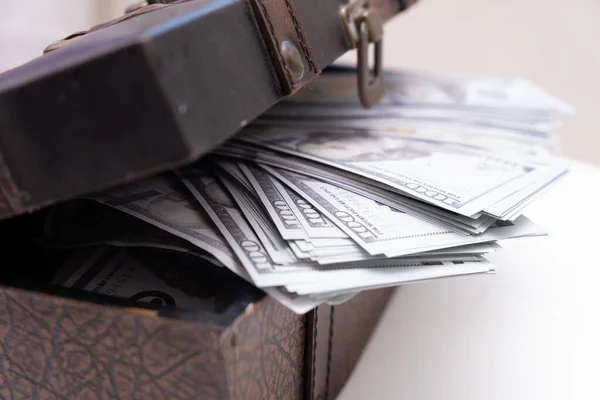 vintage open chest with lots of money dollar bills. Concept of wealth and abundance