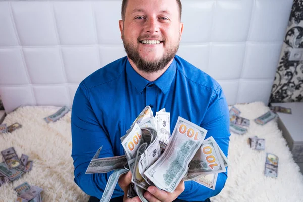 Male holds in his hands a lot of money. A man enjoys a lot of cash dollars. Tremendous wealth concept — Stock Photo, Image