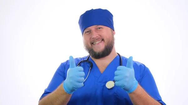 Bearded smiling male medical worker showing thumbs up sign. — Stock Photo, Image