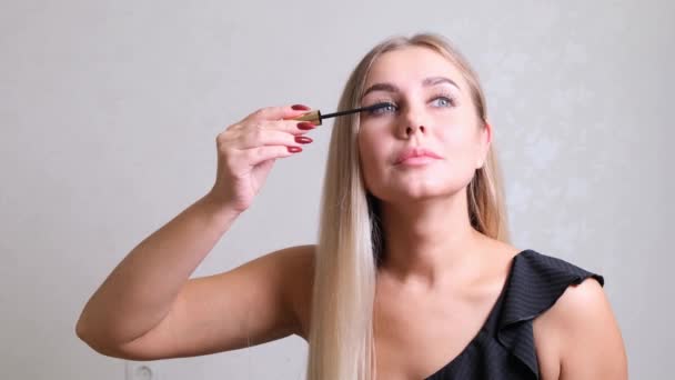 Oog make-up. Mooie vrouw die mascara op wimpers aanbrengt. glimlachende vrouw maken wimpers make-up met borstel. — Stockvideo