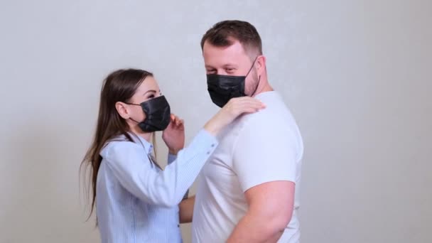 Mujer y hombre se quitan sus máscaras protectoras y se besan. Concepto de higiene. prevenir la propagación de gérmenes y bacterias y evitar la infección con el virus de la corona — Vídeos de Stock