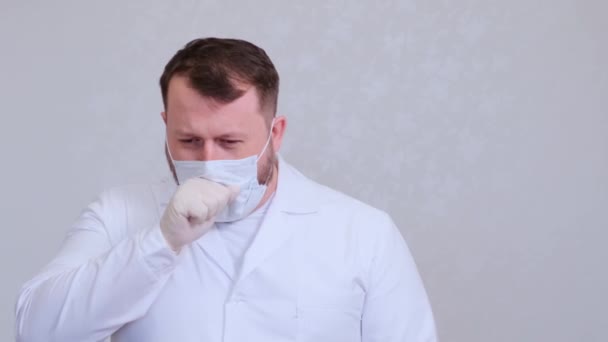 El médico tose con una máscara protectora infectada con un virus o coronavirus . — Vídeos de Stock