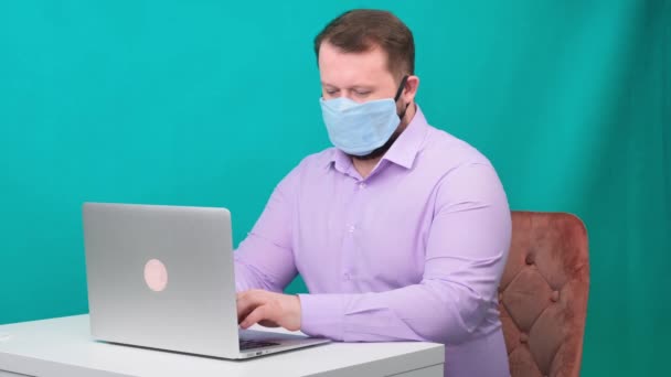 Caucasian adult bearded man works at home. Lifestyle concept photo with copy space. picture with a handsome guy who uses a protective mask. — Stock Video