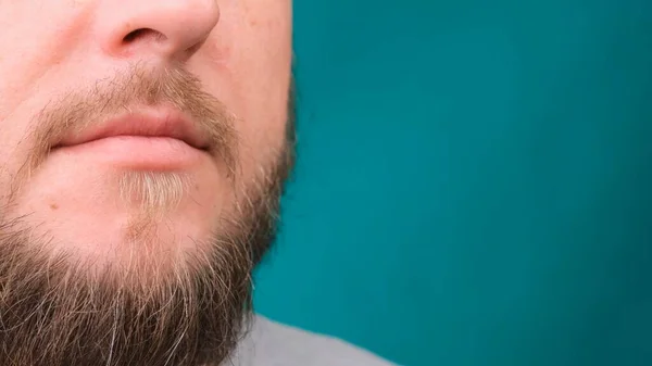Close up of male bearded face and mouth on green screen, copy space. — Stock Photo, Image