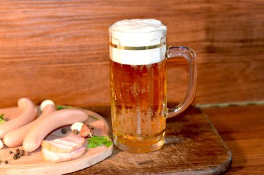 Light beer with sausages in the kitchen.