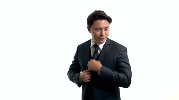 Attractive businessman standing against white background — Stock Video