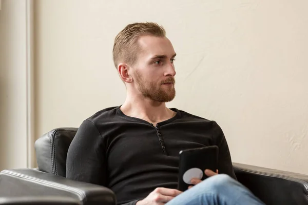 Handsome man with digital reader — Stock Photo, Image