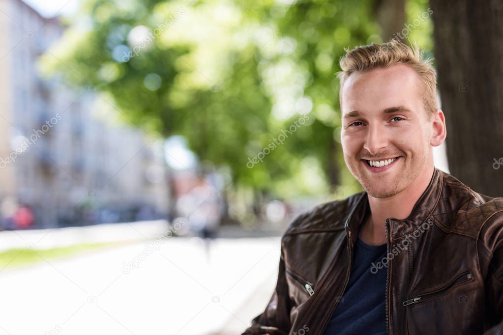 Portrait of a smiling man in an urban environment