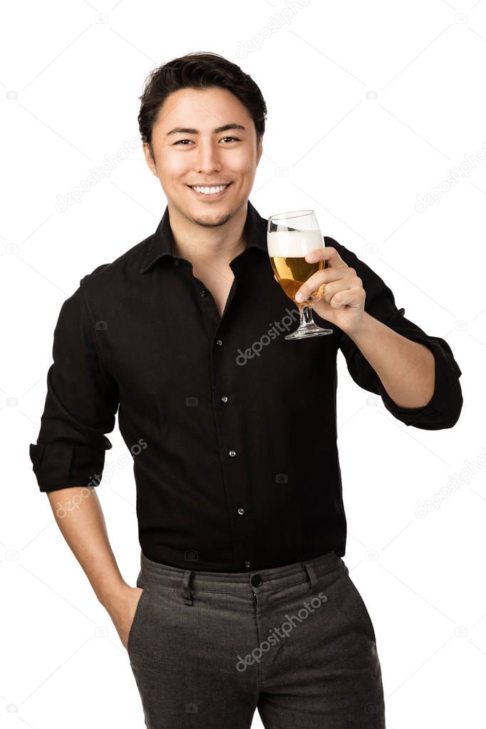 Happy smiling man in a black shirt and pants, holding a great cold beer in his hand with a big smile on his face. White background.
