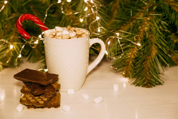 Enameled Cup of hot cocoa with marshmallows, chocolate chunks and chocolate chip cookies