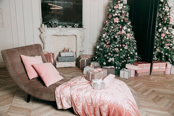 New Year\'s decor idea for a living room with gifts under a Christmas tree.
