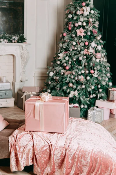 New Year's decor idea for a living room with gifts under a Christmas tree.