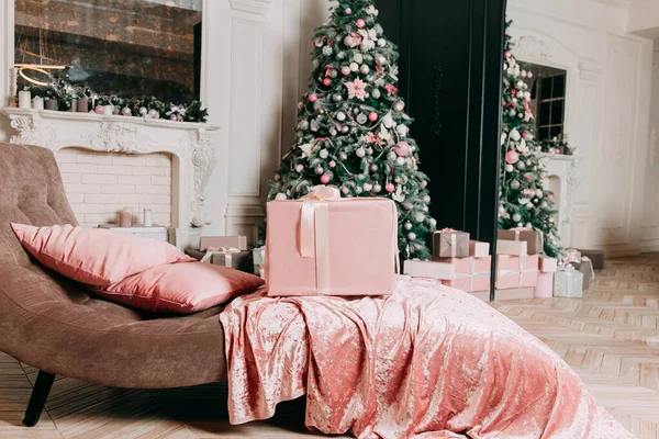 New Year\'s decor idea for a living room with gifts under a Christmas tree.