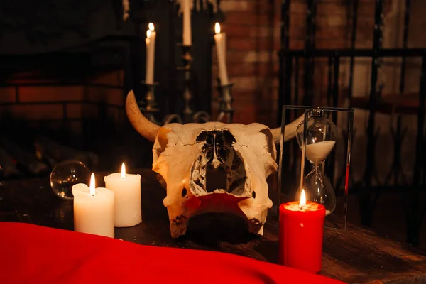 Witchcraft composition with skull, candles, magic book. occult concept, black magic ritual.