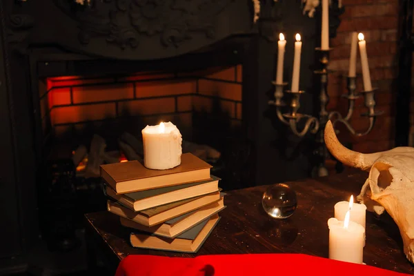 Witchcraft composition with skull, candles, magic book. occult concept, black magic ritual.