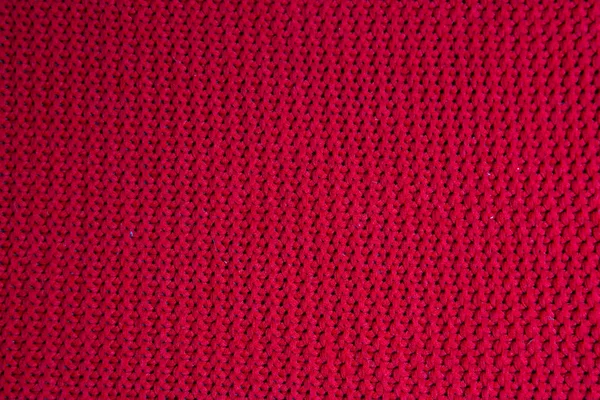 Texture of real dark burgundy knitwear, textile background. Dark red knitted background