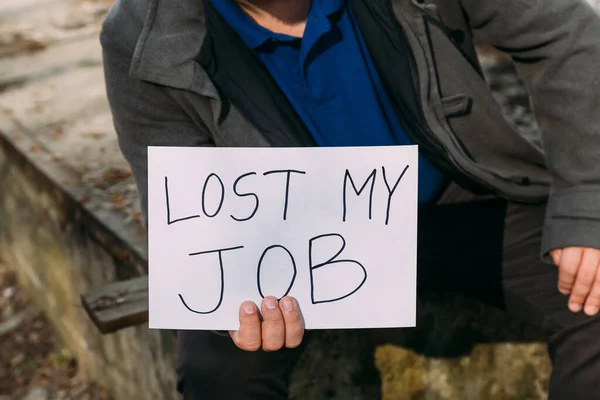 Job loss due to COVID-19 virus pandemic concept. man holds sign lost my job