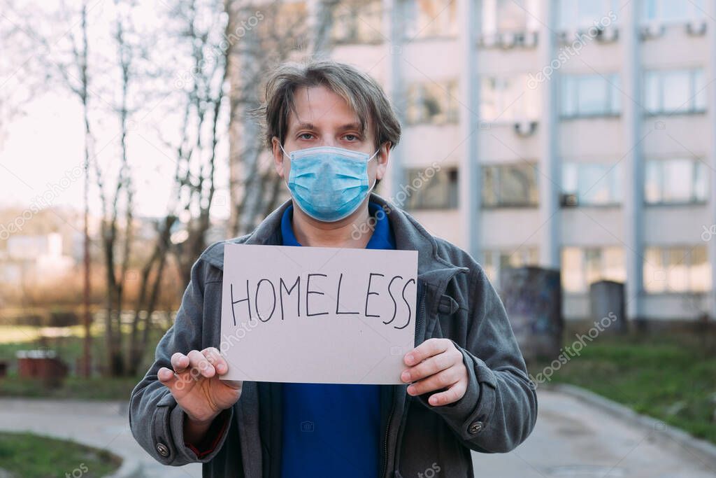 sick homeless in a medical mask caught a cold