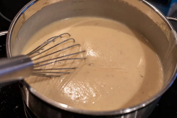Cooking of bechamel sauce in a pot — Stock Photo, Image