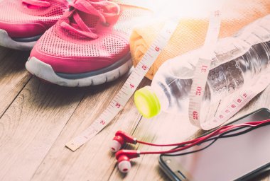 Spor ayakkabı, havlu, su, mezura, kulaklık ve akıllı telefon 