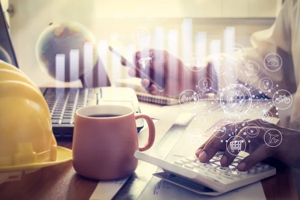 Hands of architect holding smart phone on office desk. — Stock Photo, Image