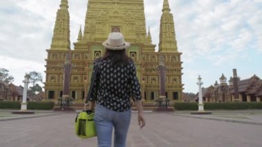  Budist tapınağında yürüyen Asyalı kadın turist büyük bir pagoda görmek istiyor. Bang Thong Tapınağı Tayland 'daki en ünlü ve güzel Budist tapınağıdır..