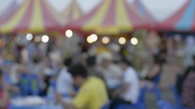 Pofetteki yerel yemek festivalindeki bulanık insanlar. Tayland 'daki markette sokak yemeği yiyen tanınmamış insanlar..