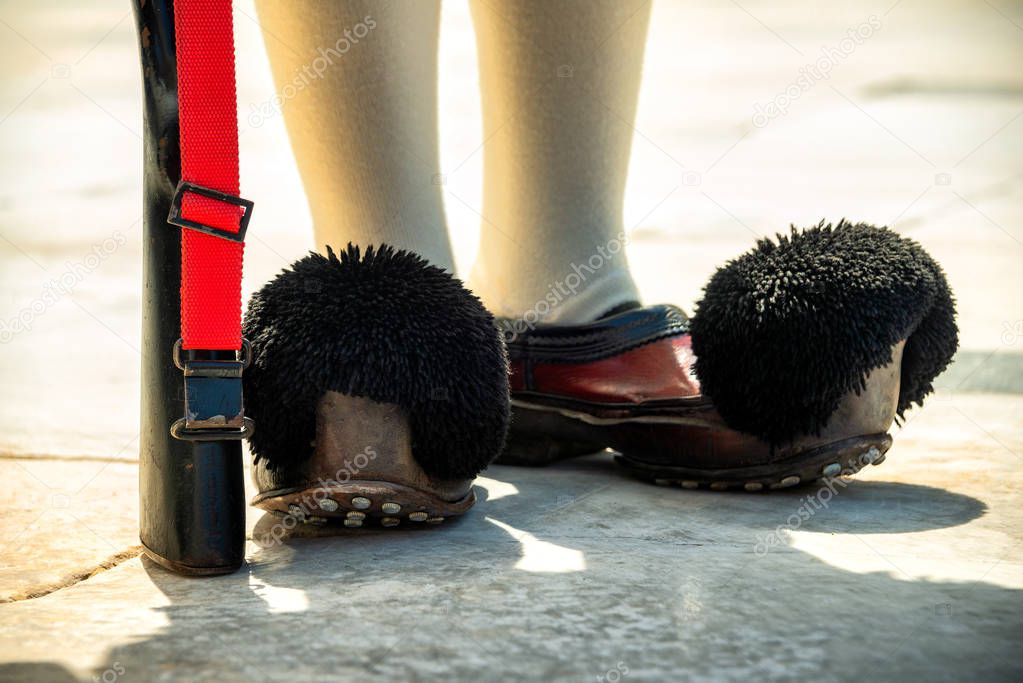 Greece, Athens: Detail close up of traditonal boots of the Presidential Guard soldiers (Evzones or Evzonoi) in the city center of the Greek capital - concept history tradition ceremony elite military