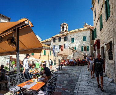 Old historical buildings with street cafe in the central district of ancient city Kotor in Montenegro.