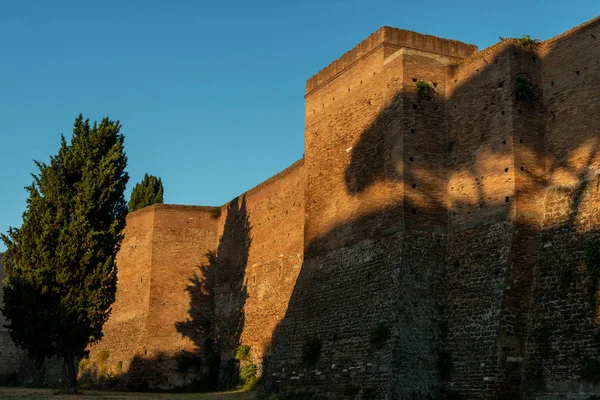 Scenic view of Aurelian Walls in Rome, Italy. The ancient Roman fortress walls of Rome in summer. Overgrown stone city walls