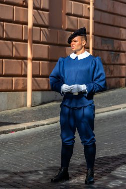 Pontifical Swiss Guard in traditional everyday blue uniform with a black beret. The guards are responsible for the security of Vatican clipart