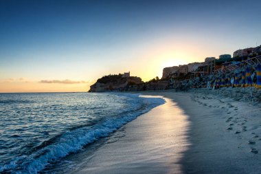 Early Morning view on Tropea an Beach with the Sanctuary of Santa Maria in the very back clipart