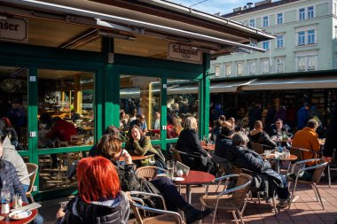 People have lunch in a restaurant of the famous area of the market Naschmarkt in Vienna, Austria. The popular Naschmarkt has existed since the 16th century clipart