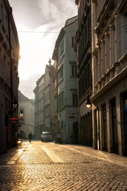 Old cobbled deserted street in the center of the city in the early morning light