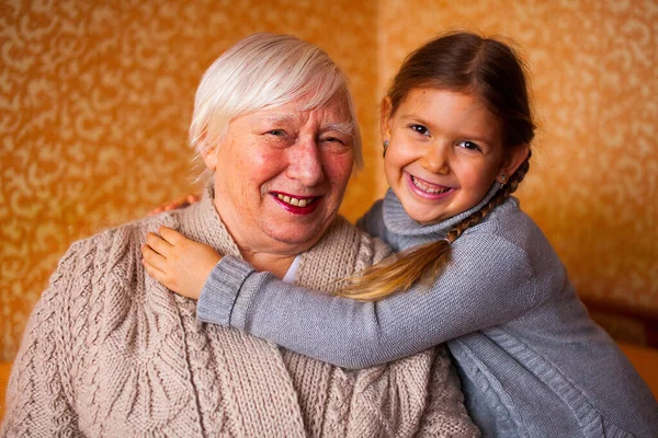 Indoor portrait of senior grandmother with grandaugther — Stock Photo, Image