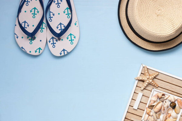 Beach accessories on wooden board. Vacation and travel items, top view