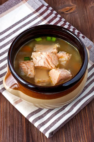 Salmon soup with vegetables in ceramic  bowl