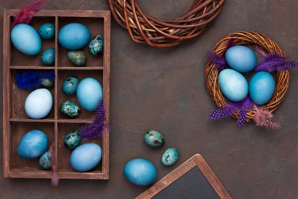 Easter spring  background with decoration - wooden slate blackboard and  color eggs