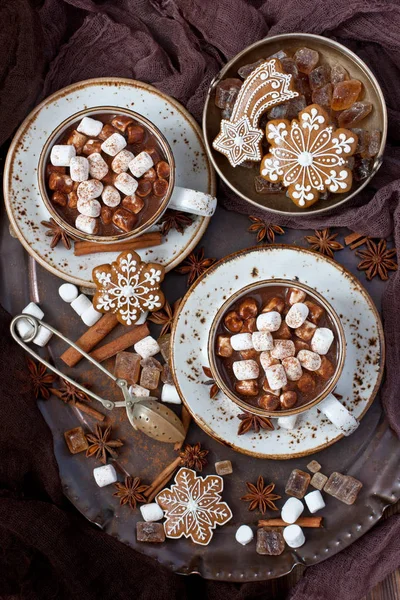 Cup of creamy hot chocolate with melted marshmallows and gingerbread cookies  for christmas holiday