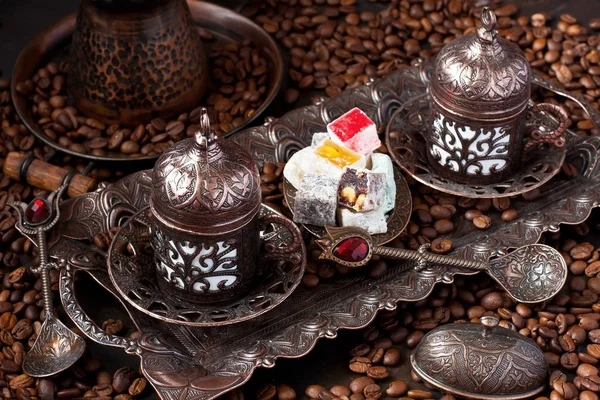 Coffee  in cups and Turkish Delight on copper tray on  dark  background — Stock Photo, Image