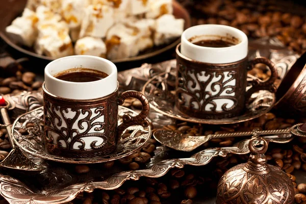 Traditional Turkish coffee in traditional copper cups on  dark table — Stock Photo, Image