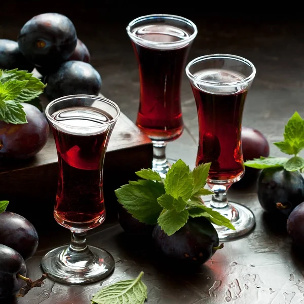 Alcoholic liqueur from plums in glasses — Stock Photo, Image