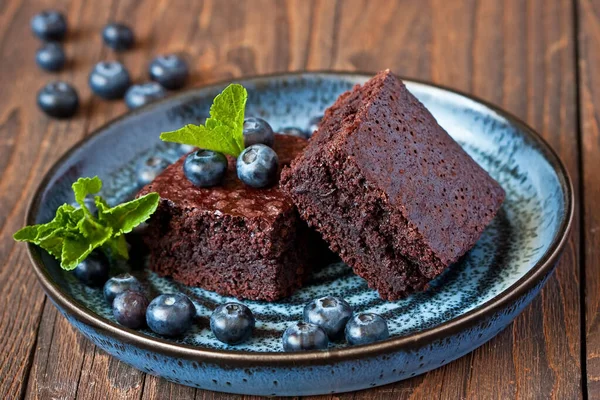 Chocolate dessert concept with brownie cakes, berries on dark table, selective focus with  shallow depth of field