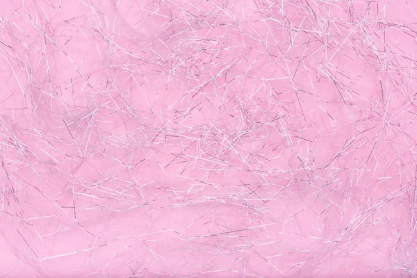 Trituradores de purpurina. Textura de papel brilhante espumante para o Natal. Trituradores de prata no fundo rosa . — Fotografia de Stock