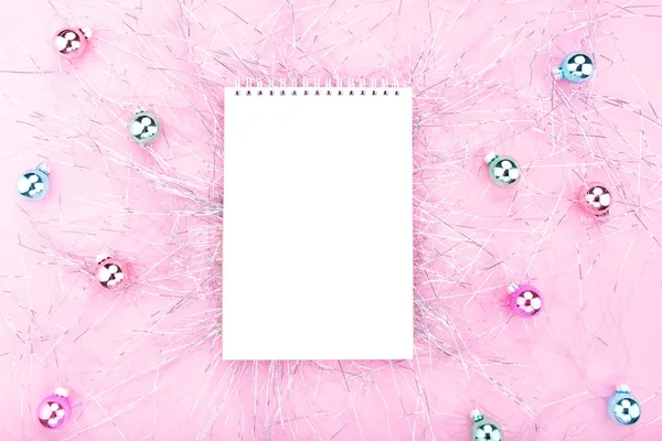 Silver sparkles decoration with notebook on pink background. — Stock Photo, Image