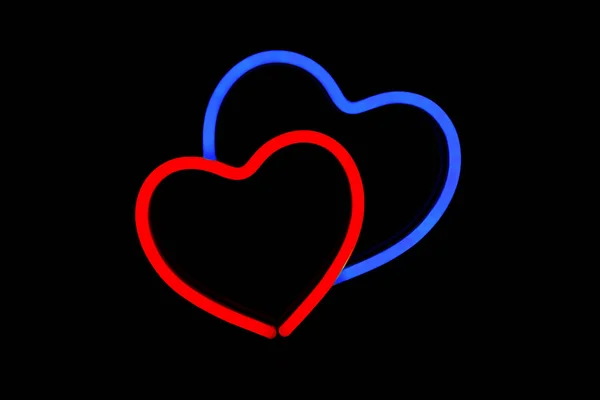 Cuore rosso e blu in un segno al neon su sfondo nero isolato . — Foto Stock