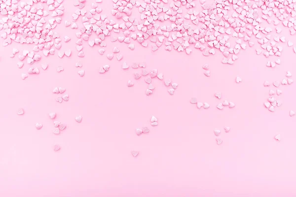 Pink background. Pink hearts on a pink background. Hearts sprinkles. Valentine day. — Stock Photo, Image