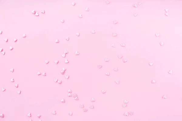 Pink background. Pink hearts on a pink background. Hearts sprinkles. Valentine day. — Stok fotoğraf