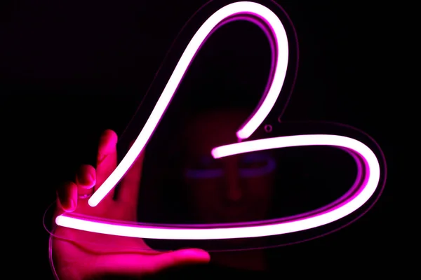 Valentine day. Hipster handsome man with neon signs. Neon sign pink heart. — 스톡 사진